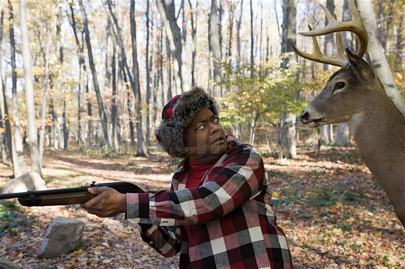 Deer standing behind a hunter, stock photo
