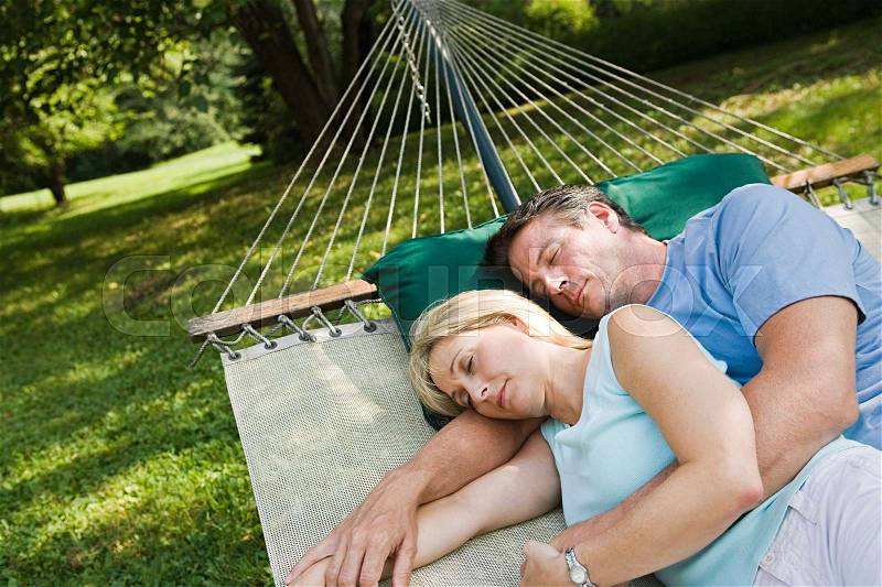 Couple lying in hammock, stock photo