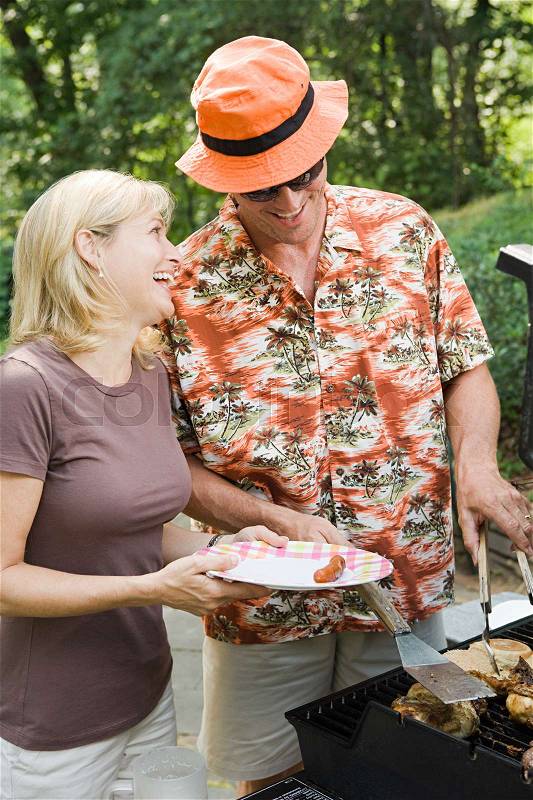 Couple having a barbecue, stock photo