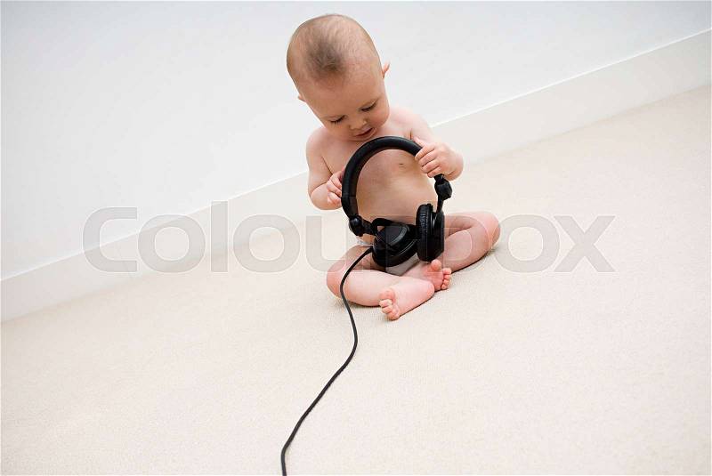 Baby with head phones, stock photo