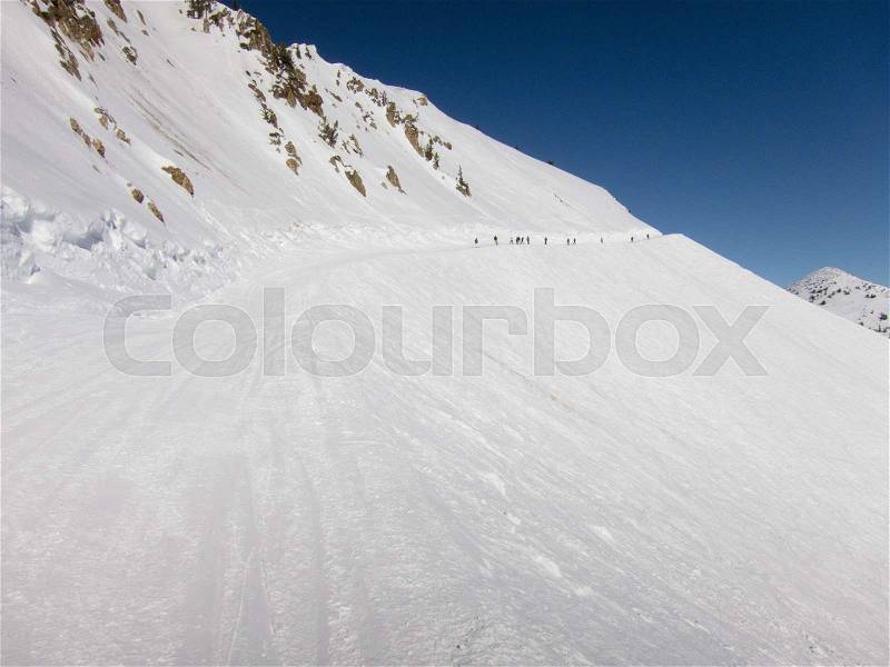 Skiers coming down hill, Utah, USA, stock photo