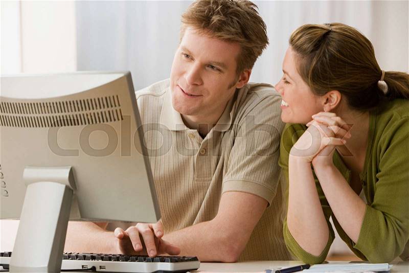 Couple using computer, stock photo