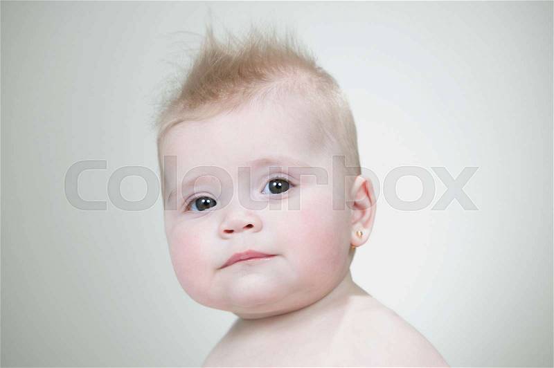 Baby girl with spiked hair, stock photo