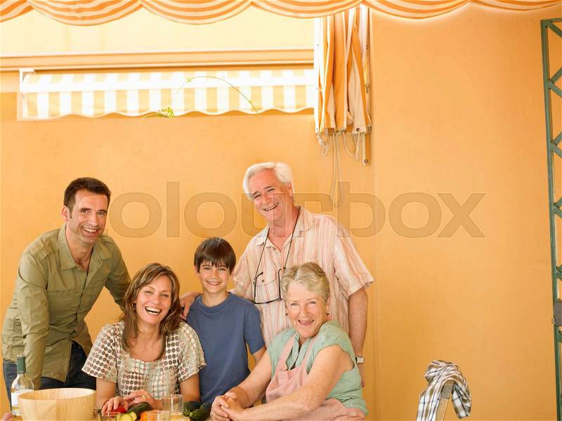 Multi-generational family preparing food, stock photo