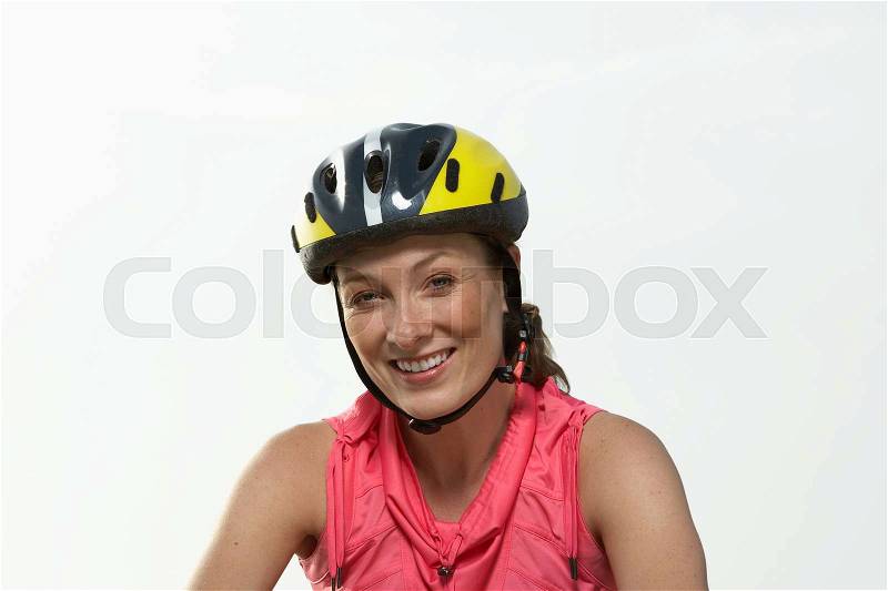 Portrait of a woman in a cycle helmet, stock photo