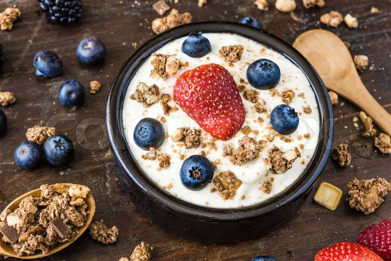 Serving of Fresh White Yogurt with Raspberry, Blueberries and Muesli, stock photo