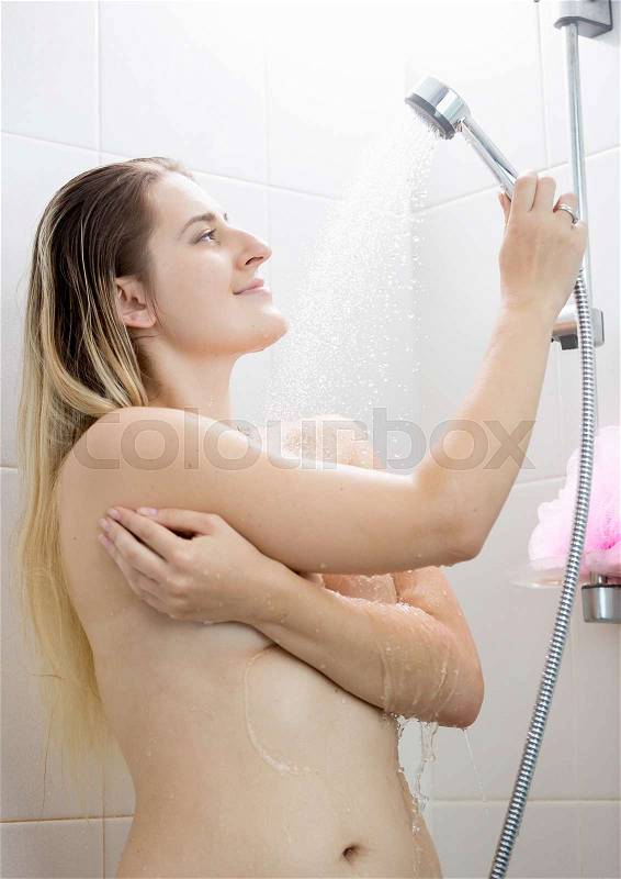 Rear view image of beautiful woman with long hair at shower, stock photo