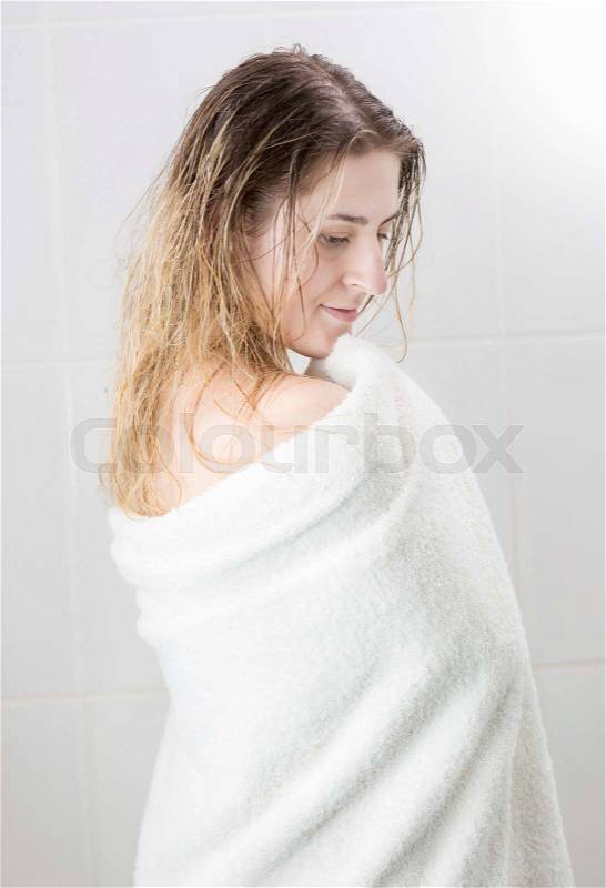 Rear view of woman with long hair wiping with towel, stock photo