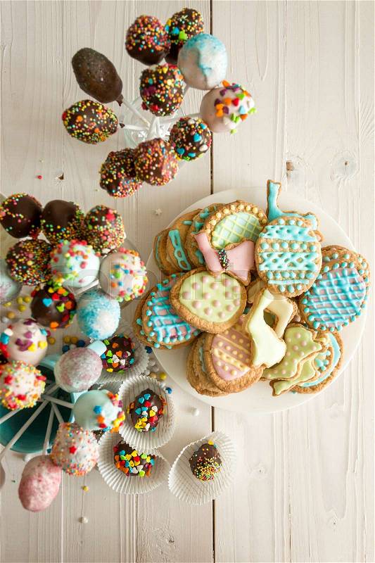 Top view photo of colorful cake pops and Easter cookies, stock photo