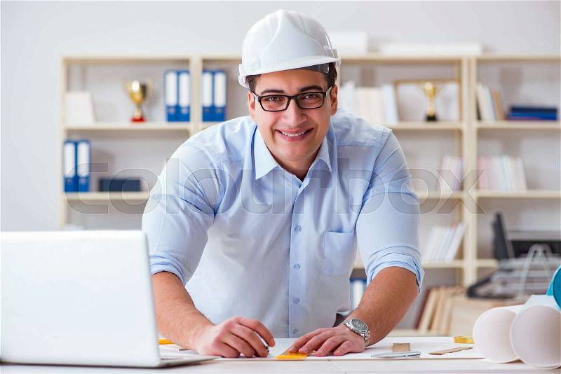Male engineer working on drawings and blueprints, stock photo