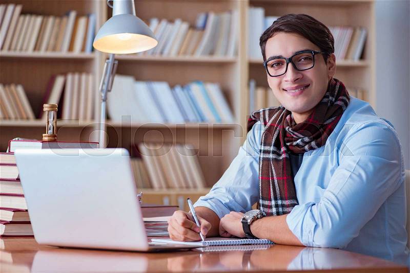 Young book writer writing in library, stock photo