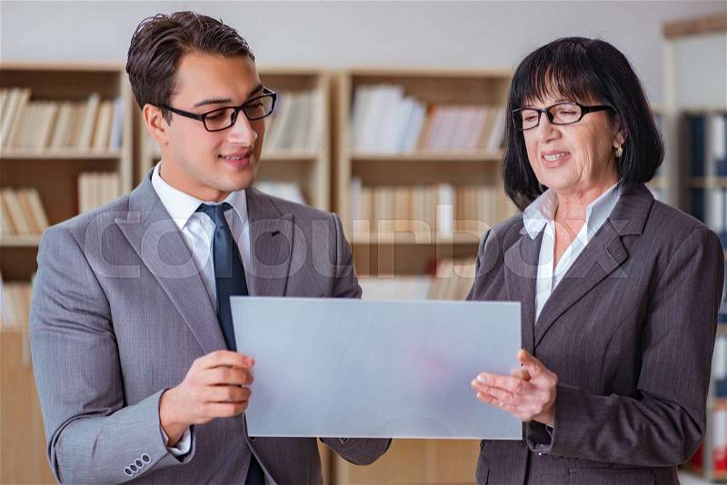 Businesspeople discussing business results on tablet computer, stock photo