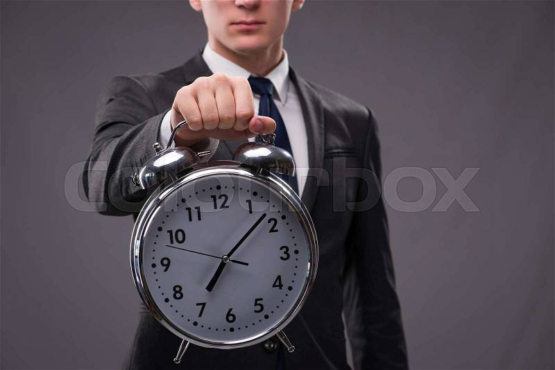 Businessman in time management concept, stock photo