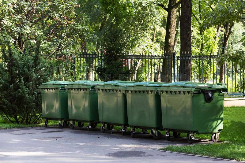 Plastic containers for garbage in the green park, stock photo