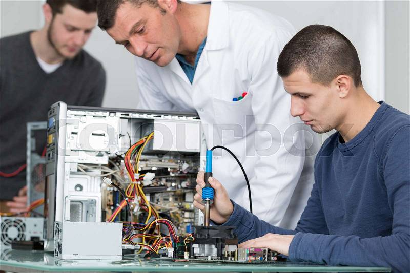 Student in technology fixing computer processing, stock photo