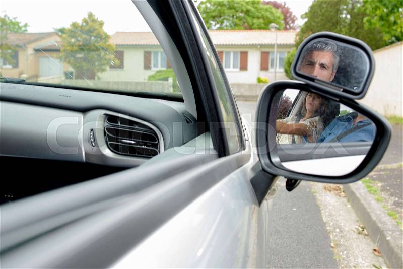 Young woman getting a driving lesson in the car, stock photo