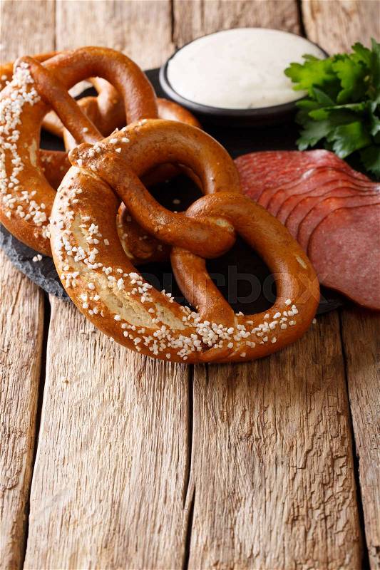 Traditional German pretzels, sausages and cream sauce close-up on the table. vertical , stock photo