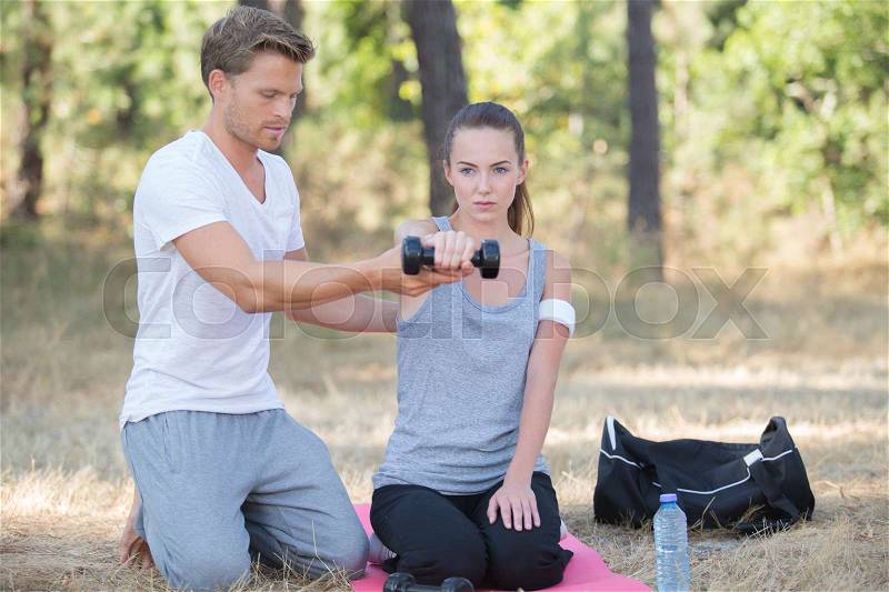 Woman and personal training working out outdoors, stock photo