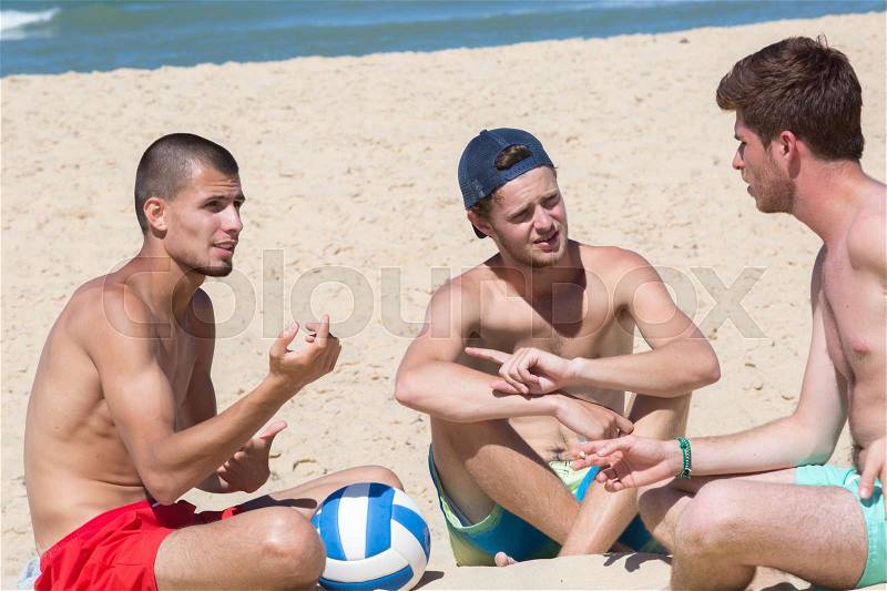 Friends with volley ball at the beach, stock photo