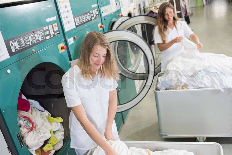 Women working at an industrial laundry, stock photo