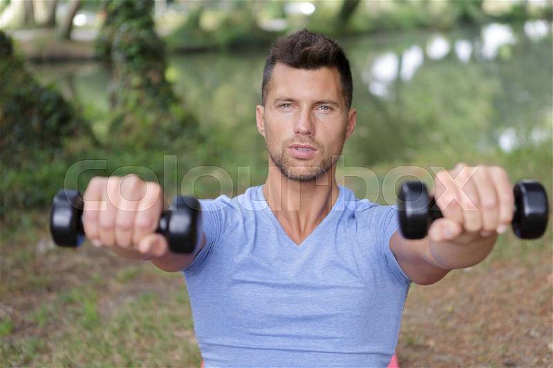 Male sports model exercising outside as part of healthy lifestyle, stock photo