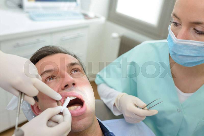 Man at a dentist suffering with pain, stock photo