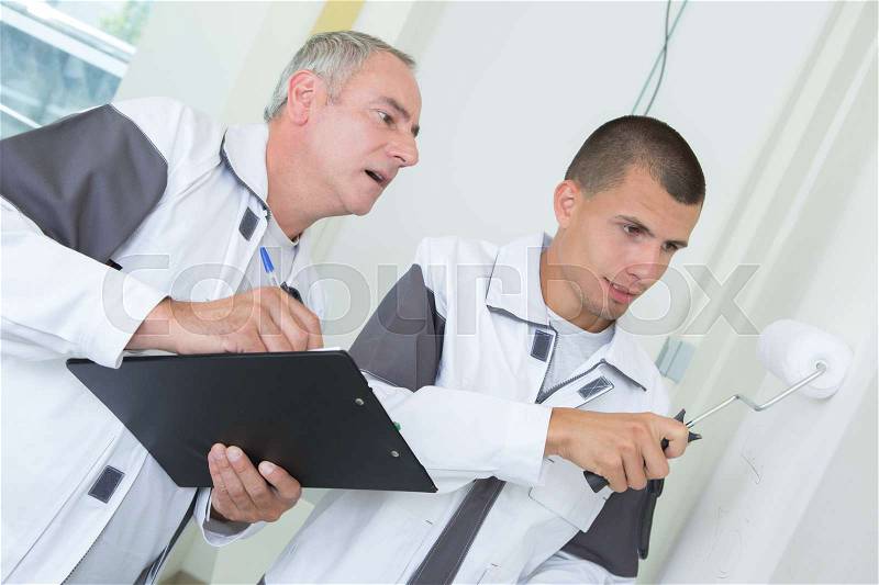 Teacher marking student on color result, stock photo
