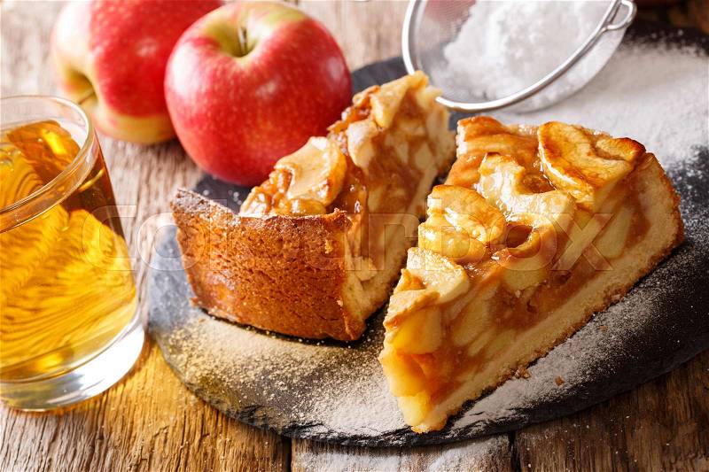 Sliced freshly baked apple pie close-up on a table and juice. horizontal , stock photo