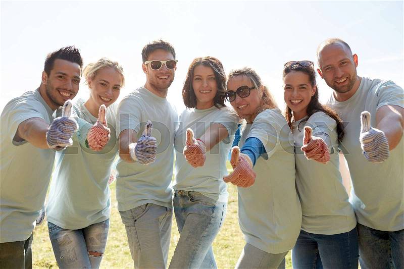 Volunteering, charity, people, gesture and ecology concept - group of volunteers showing thumbs up outdoors, stock photo
