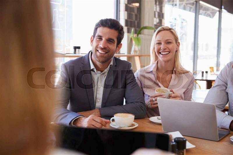 Group Of Businesspeople Having Meeting In Coffee Shop, stock photo