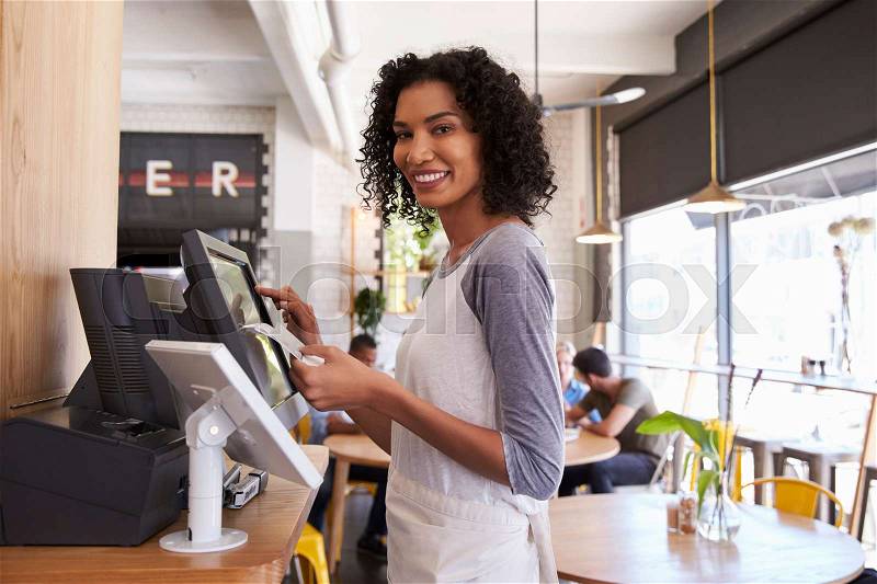 Portrait Of Waitress At Cash Register In Coffee Shop, stock photo