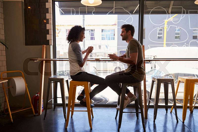 Couple Meeting For Date In Coffee Shop, stock photo