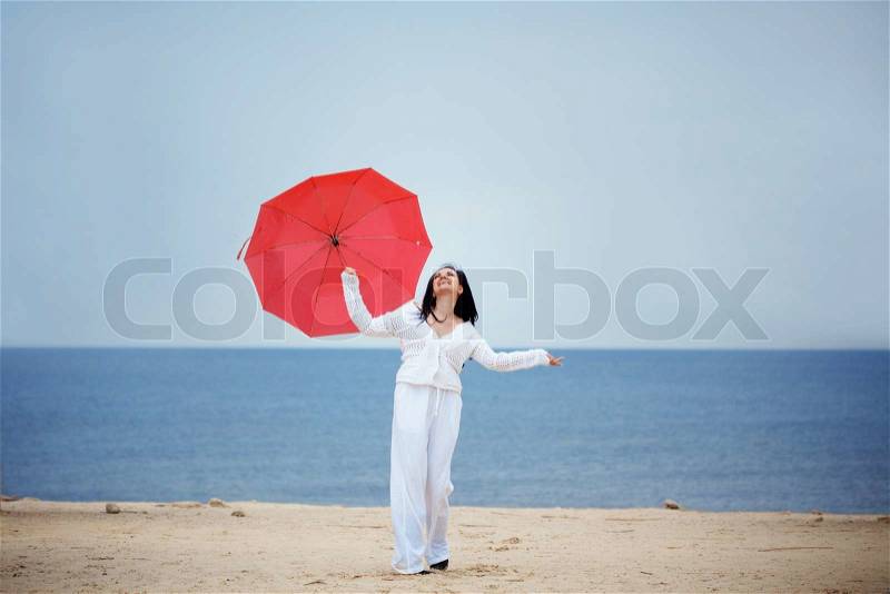 Young girl resting at beach near the sea, stock photo