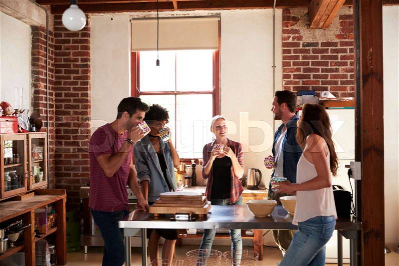 Five friends having coffee in kitchen, three quarter length, stock photo