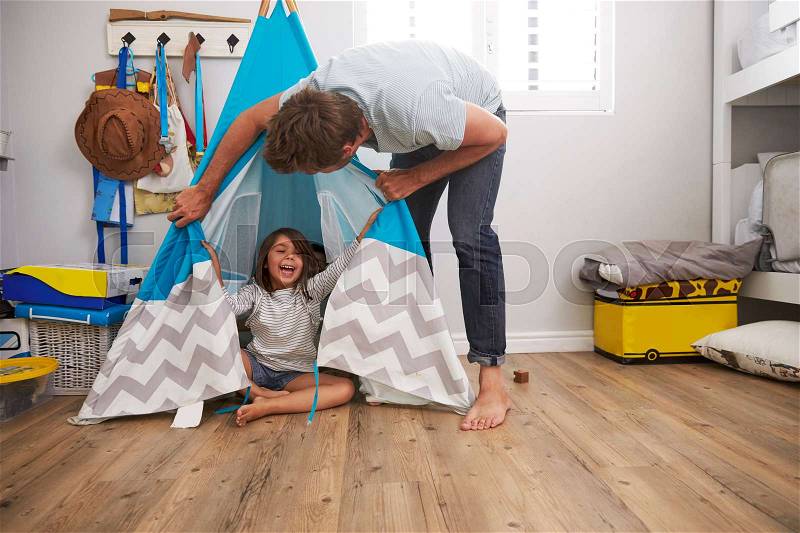 Father And Daughter Playing In Wigwam In Playroom, stock photo