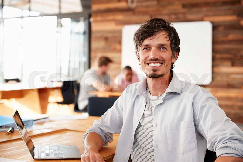 Casually dressed mid adult white man in office, portrait, stock photo