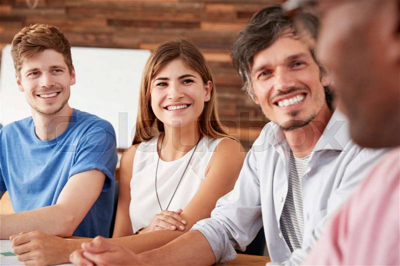 Close up of four happy work colleagues, stock photo