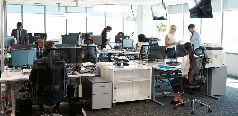 Interior Of Busy Modern Open Plan Office With Staff, stock photo