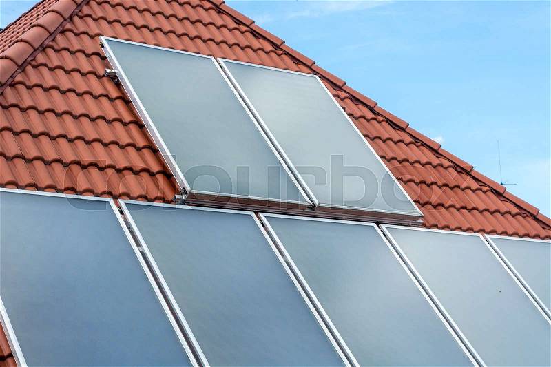 Solar panels installed on a roof with the sky, stock photo
