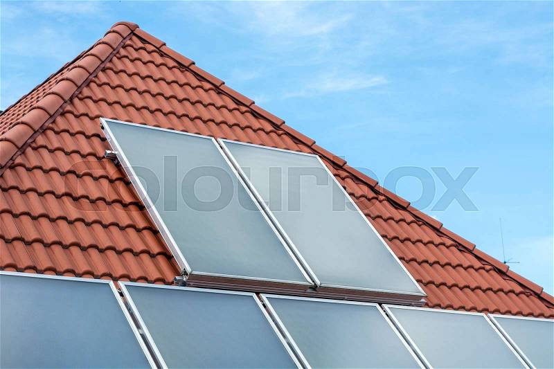 Solar panels installed on a roof with the sky, stock photo