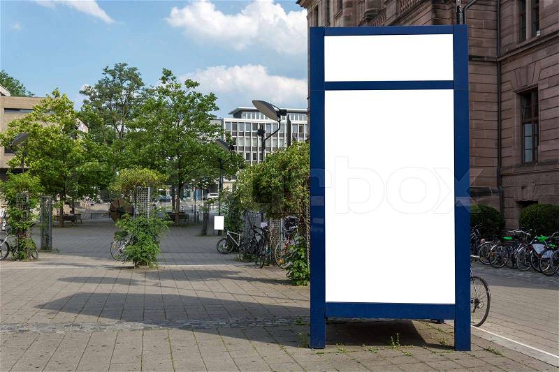 A blue blank ad space sign isolated in the street, stock photo