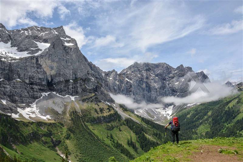 Lone hiker standing in the Austrian mountains, stock photo