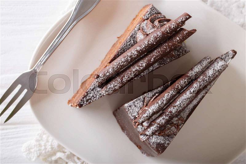 Truffle cake decorated with chocolate chips on a plate close-up on a table. horizontal view from above , stock photo