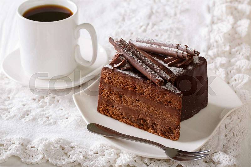 Truffle cake decorated with chocolate chips on a plate and coffee close-up on a table. horizontal , stock photo