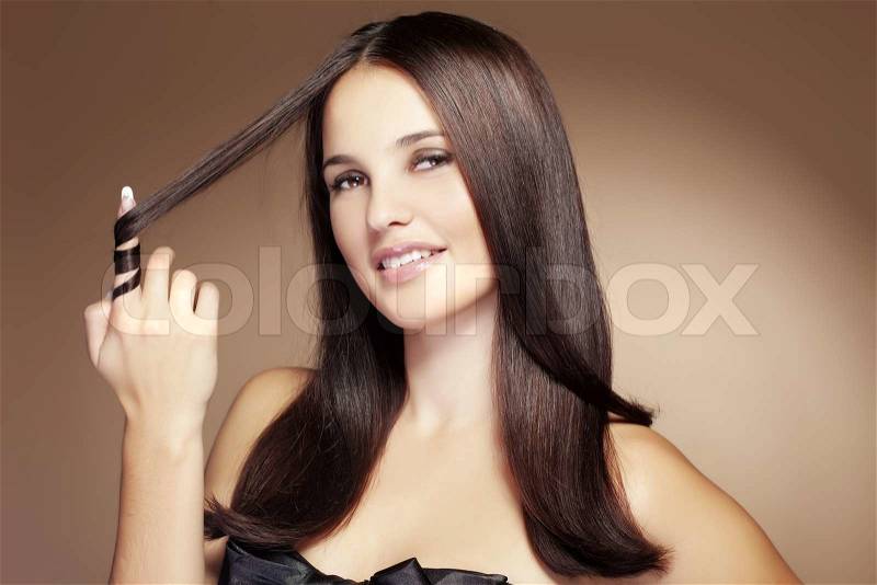 Portrait of young beautiful woman with long glossy hair, stock photo