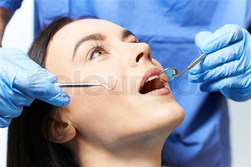 Young Woman Having Check Up And Dental Exam At Dentist, stock photo