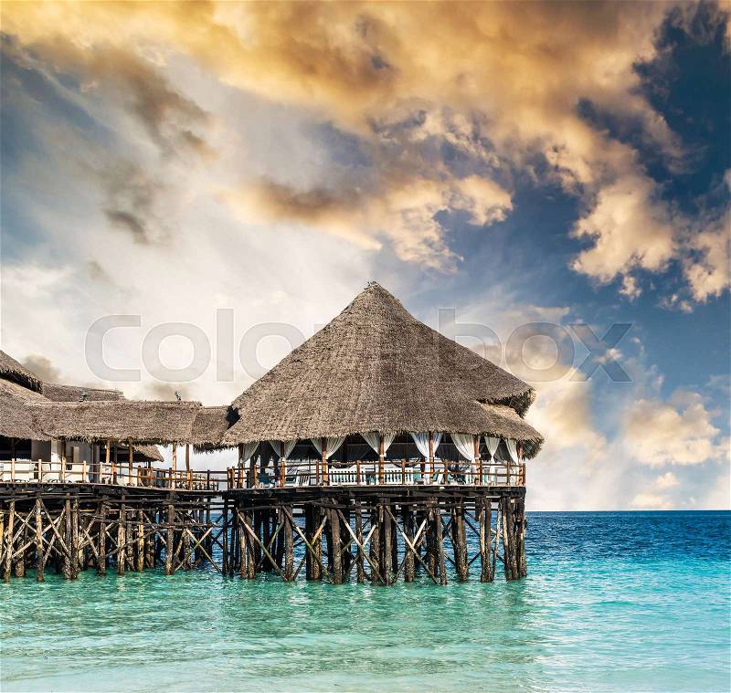 Colorful landscape with african hotel in sea on the pier, Zanzibar, stock photo