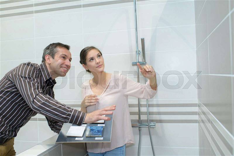 Couple buying furniture at big plumbing store, stock photo