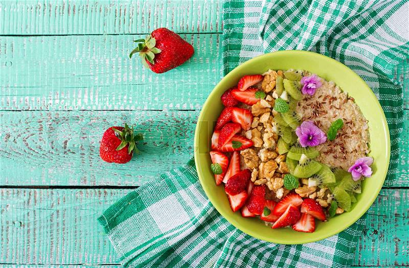 Tasty and healthy oatmeal porridge with berry, nuts and flax seeds. Healthy breakfast. Fitness food. Proper nutrition. Flat lay. Top view, stock photo