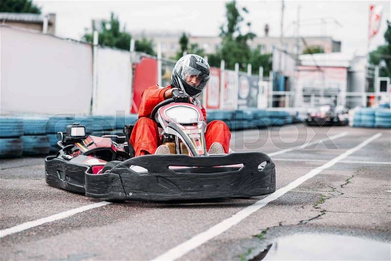 Karting racer in action, go kart competition on outdoor track. Carting championship, stock photo